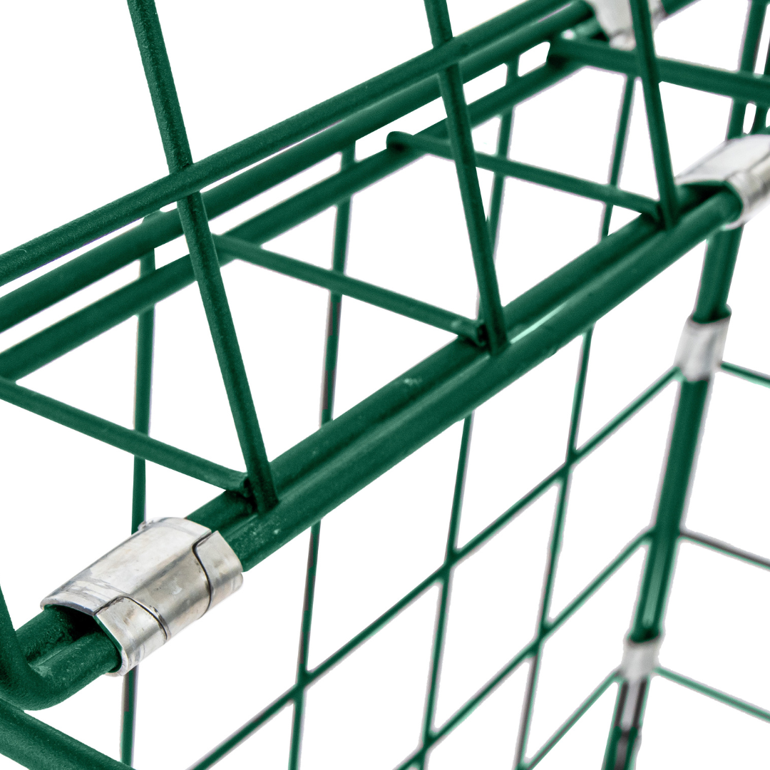 Close-up of a green metal cage with a silver clip on a white background