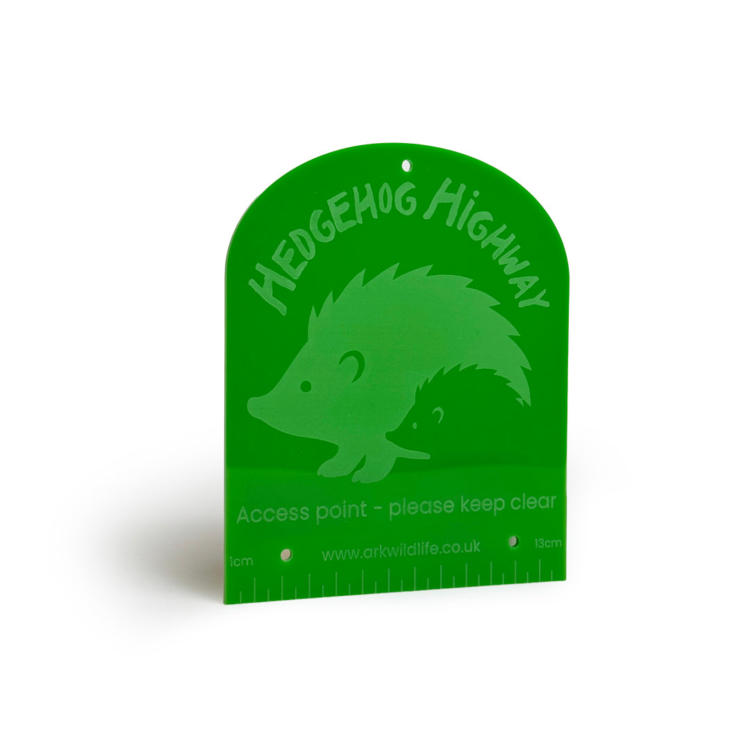 Green sign with hedgehog illustration and 'Hedgehog Highway' text on a white background