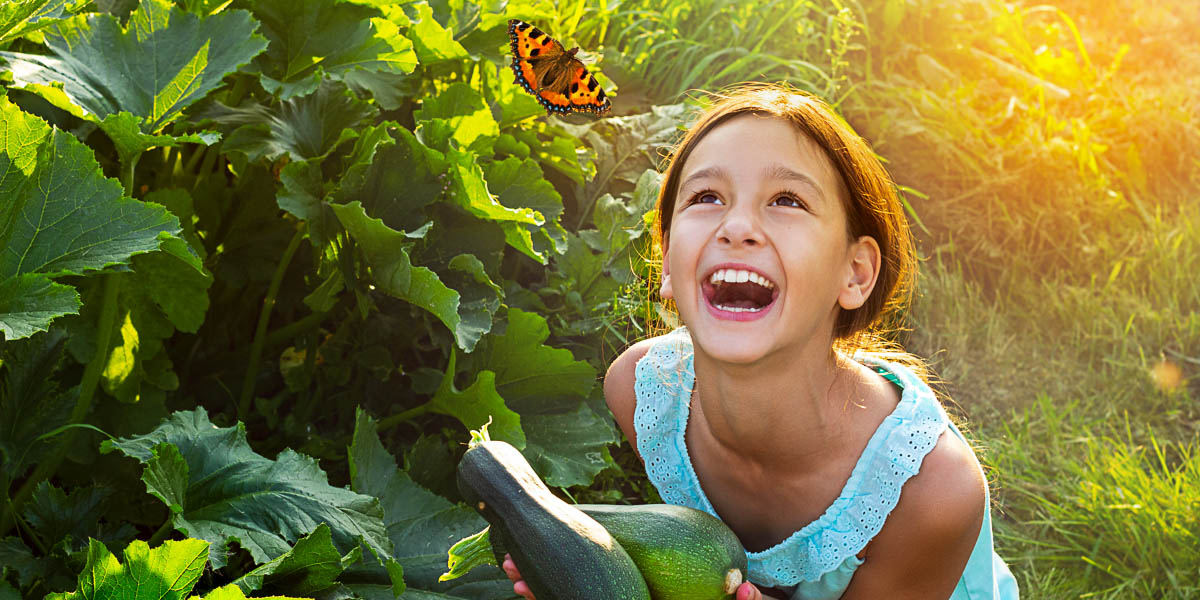 Child gardening with butterfly